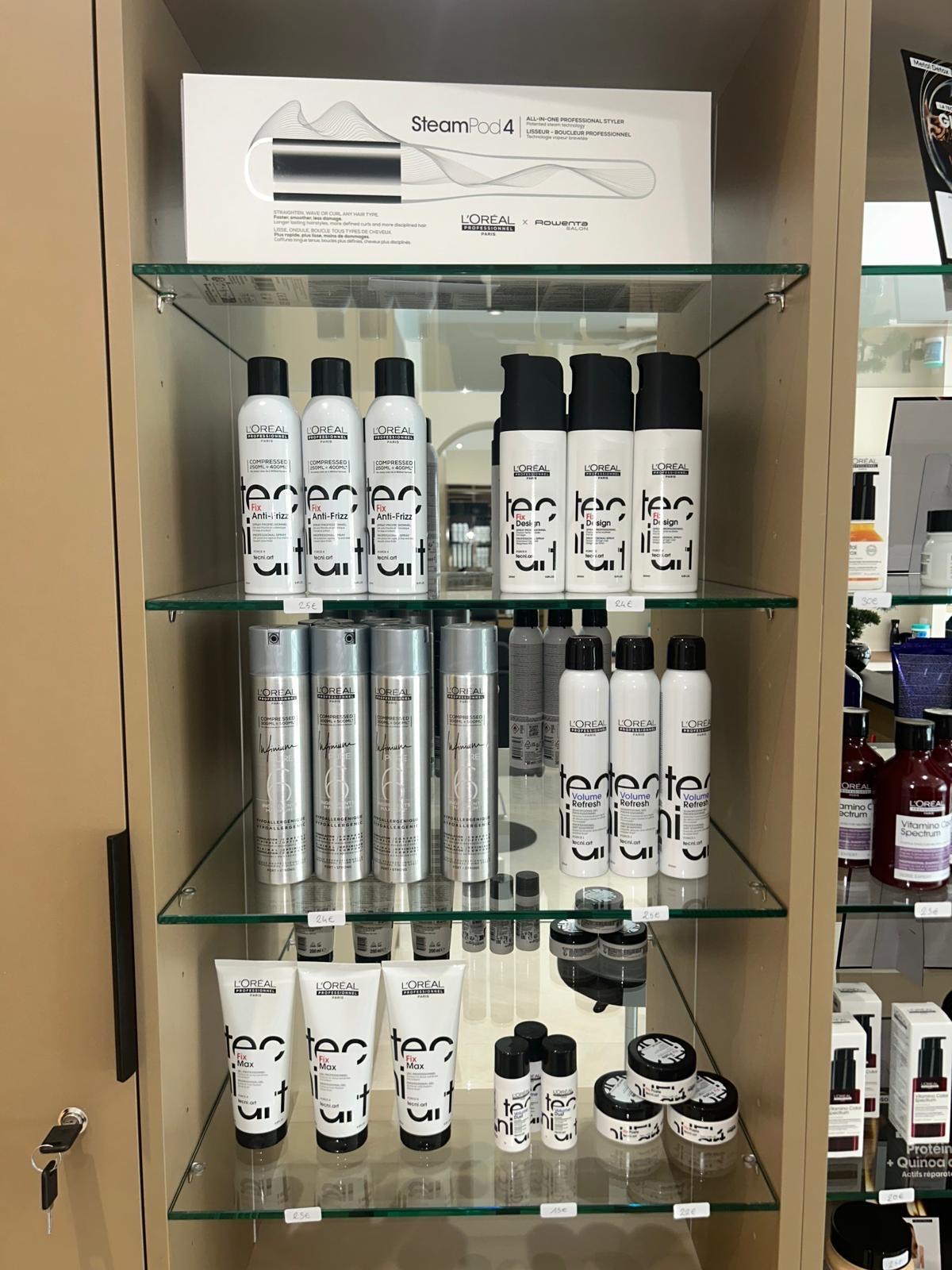 L'Oréal hair products and a SteamPod styler on a display shelf