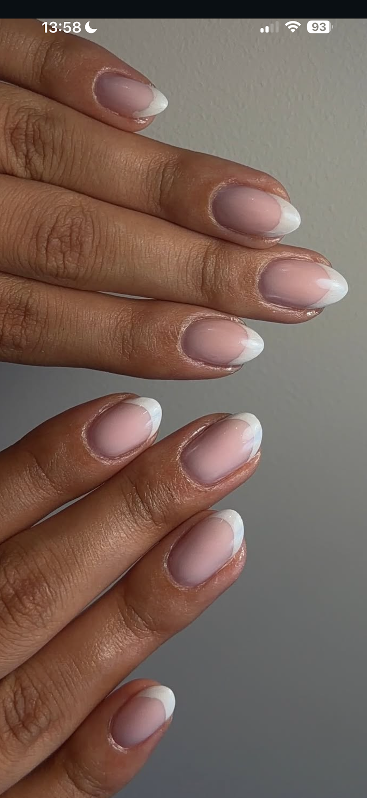 Close-up of manicured nails with a white tip finish